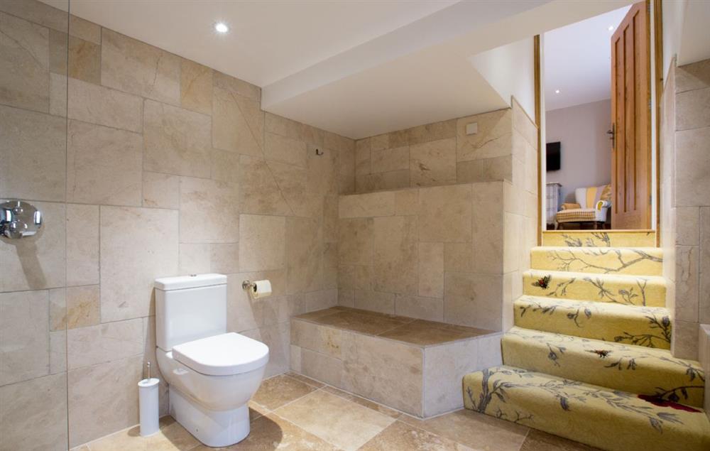 First floor: Bonscale - en-suite subterranean natural stone bathroom with bath and separate monsoon and raindrop showers