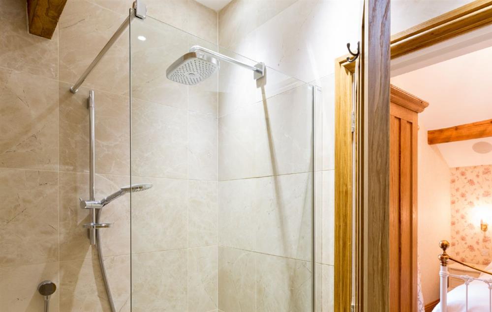 First floor: Hallin - en-suite natural stone shower room with monsoon and raindrop showers and views across Hallin Fell