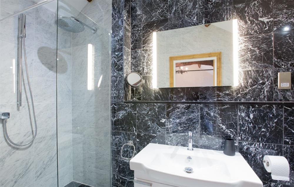 First floor: Martindale - en-suite natural black stone shower room with monsoon and raindrop showers at Waternook, Ullswater