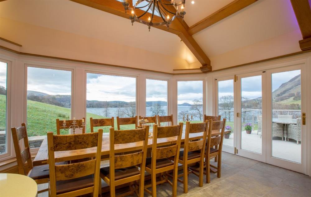 Ground floor: Dining table and chairs seating 12 and double aspect lake views with french doors opening on to terrace