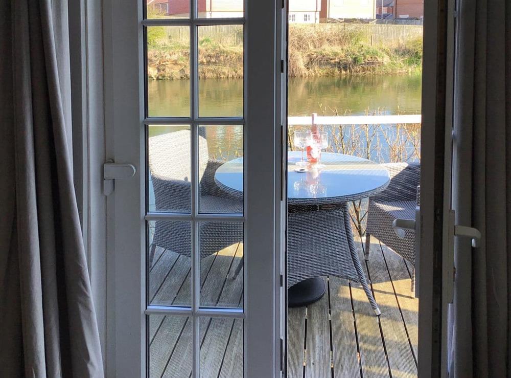 French-doors to decked sitting-out area at Waters Edge Holiday Home in Beadnell, Northumberland