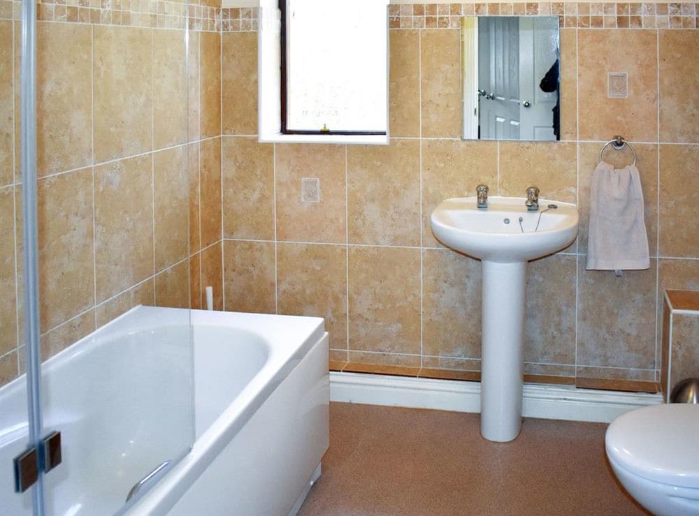 Family bathroom with shower over bath at Waters Edge in Pentney, near Kings Lynn, Norfolk
