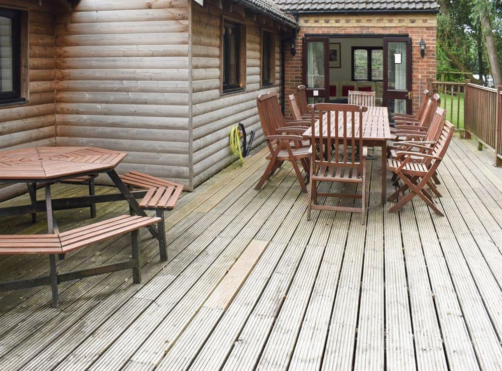 Spacious decked terrace with outdoor furniture at Waters Edge in Pentney, near Kings Lynn, Norfolk