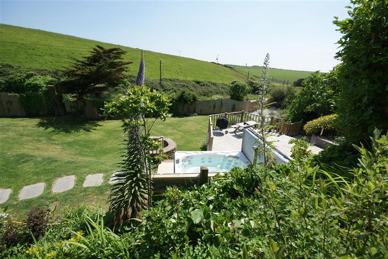 Lawned garden and hot tub at Watersend House, Watergate Bay, Cornwall