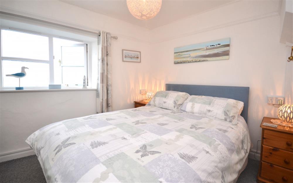 Bedroom 1 enjoys stunning views across the water. at Waterside Cottage in Appledore