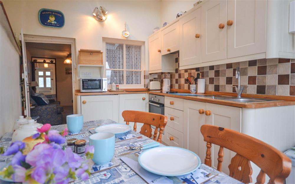 The lovely kitchen dining room leads directly out to the courtyard garden. at Waterside Cottage in Appledore