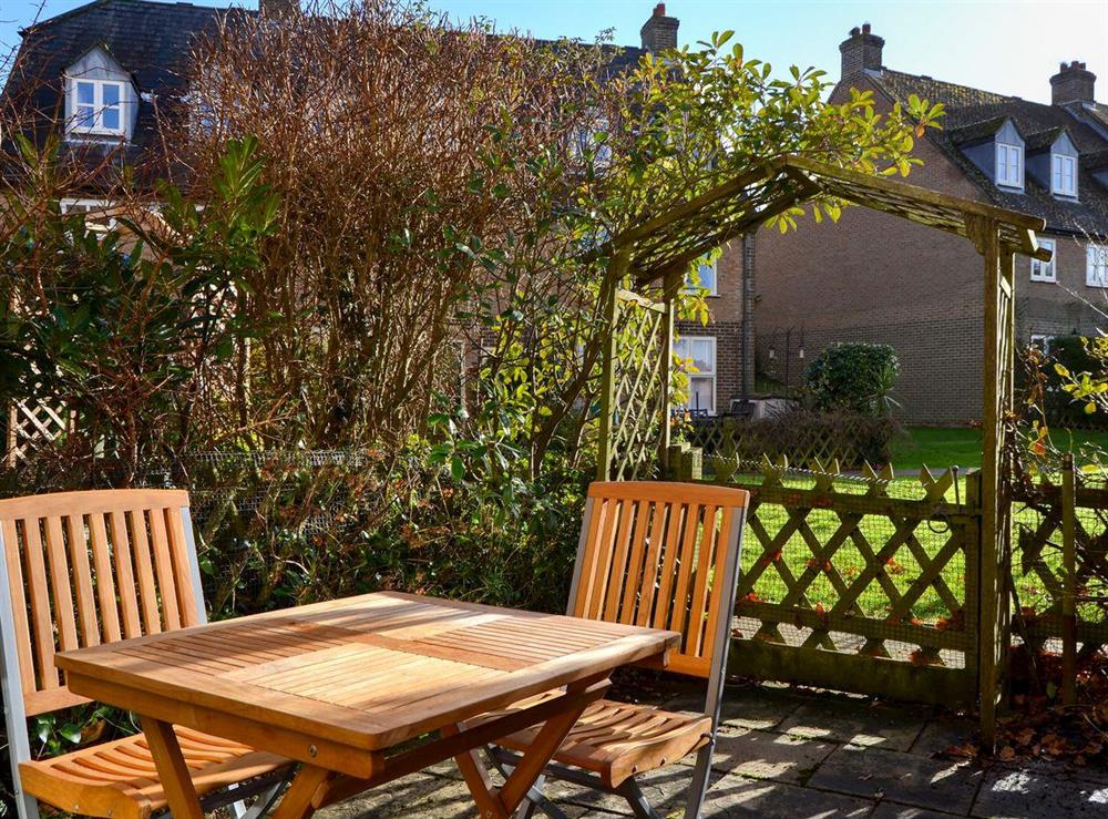 Small enclosed courtyard with patio and garden furniture at Waterside in Cowes, near Newport, Isle of Wight