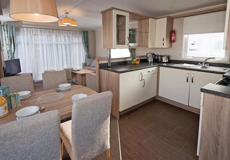 The kitchen, dining area and living room at Avonmore 3 at Waterside Holiday Park and Spa in Weymouth, Dorset
