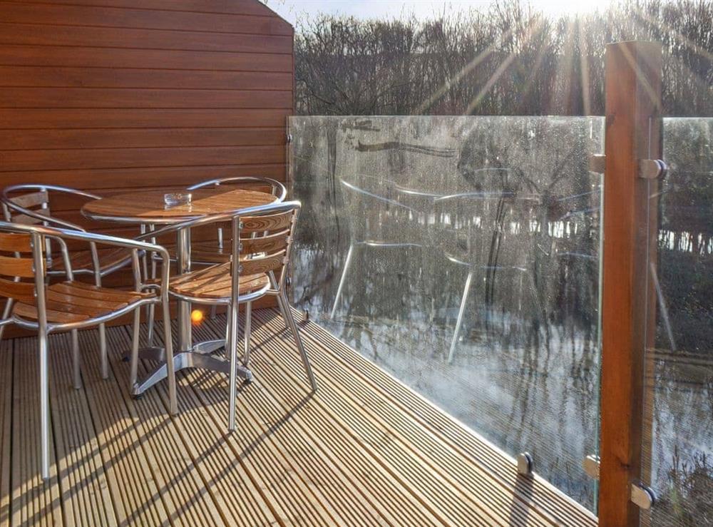 Decked patio with outdoor furniture at Waterside Lodge Sixteen in Elland, near Brighouse, West Yorkshire