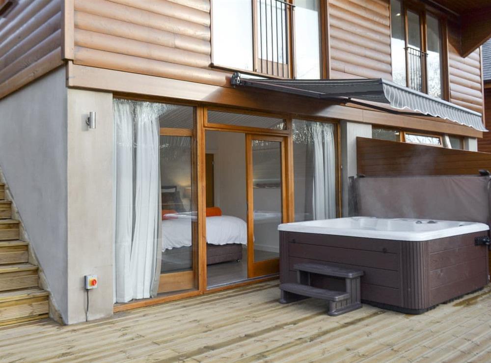 Luxurious hot tub on the decked patio at Waterside Lodge Sixteen in Elland, near Brighouse, West Yorkshire