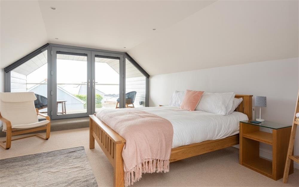 Master bedroom with balcony at Wavelet in Challaborough