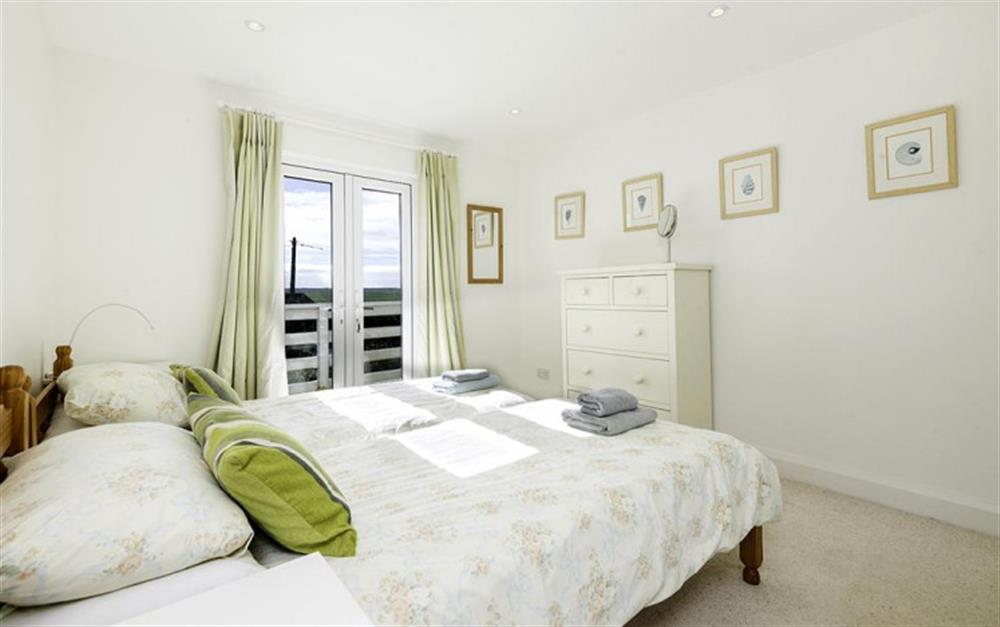 The first floor front twin bedroom with french windows to the balcony. at Wayfarings in Thurlestone