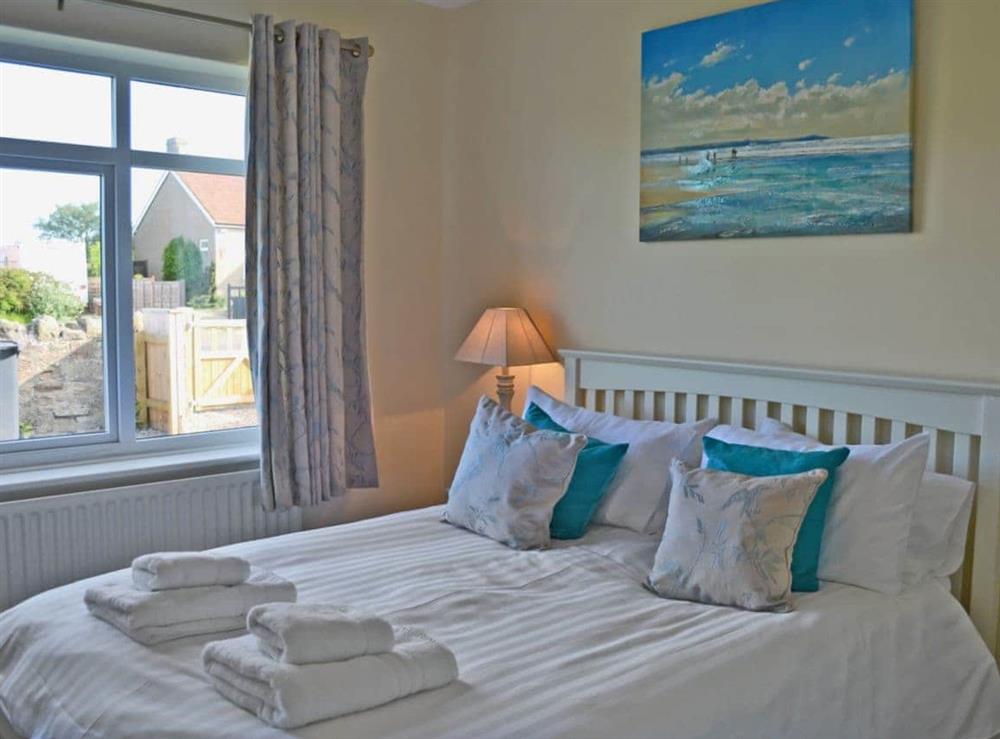 Comfortable double bedroom with kingsize bed at Wayside in Beadnell, Northumberland