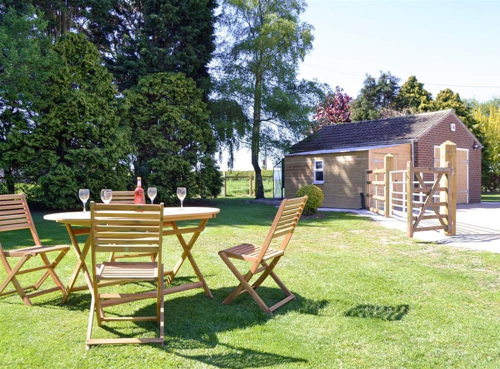 Lawned garden with outdoor furniture at Wayside Cottage in North Frodingham, near Driffield, Yorkshire, North Humberside