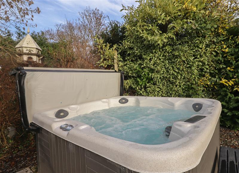 Relax in the hot tub at Wayside House, Aston On Clun