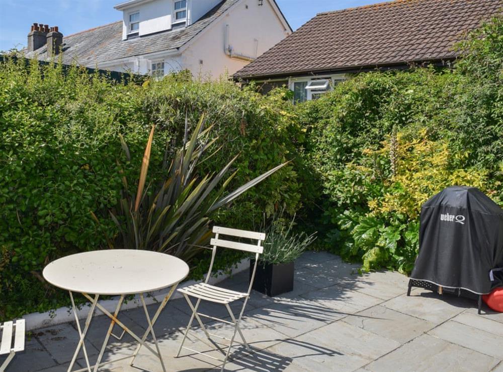 Delightful paved patio area with seating and barbecue at Weald in Salcombe, Devon