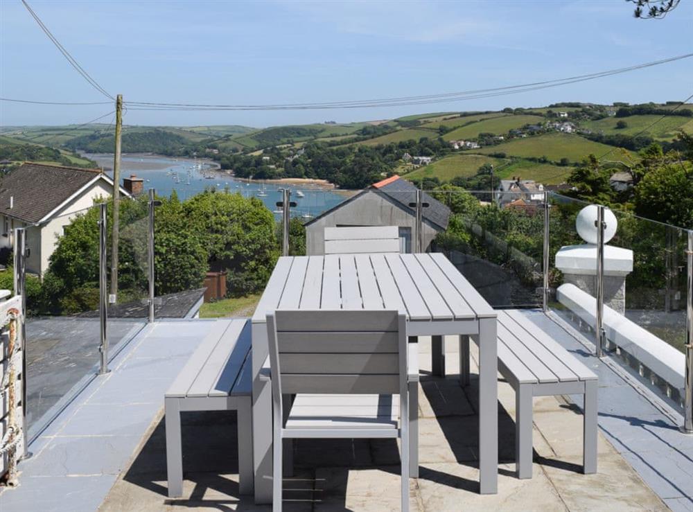 Dining on the terrace with fine views towards East Portlemouth at Weald in Salcombe, Devon