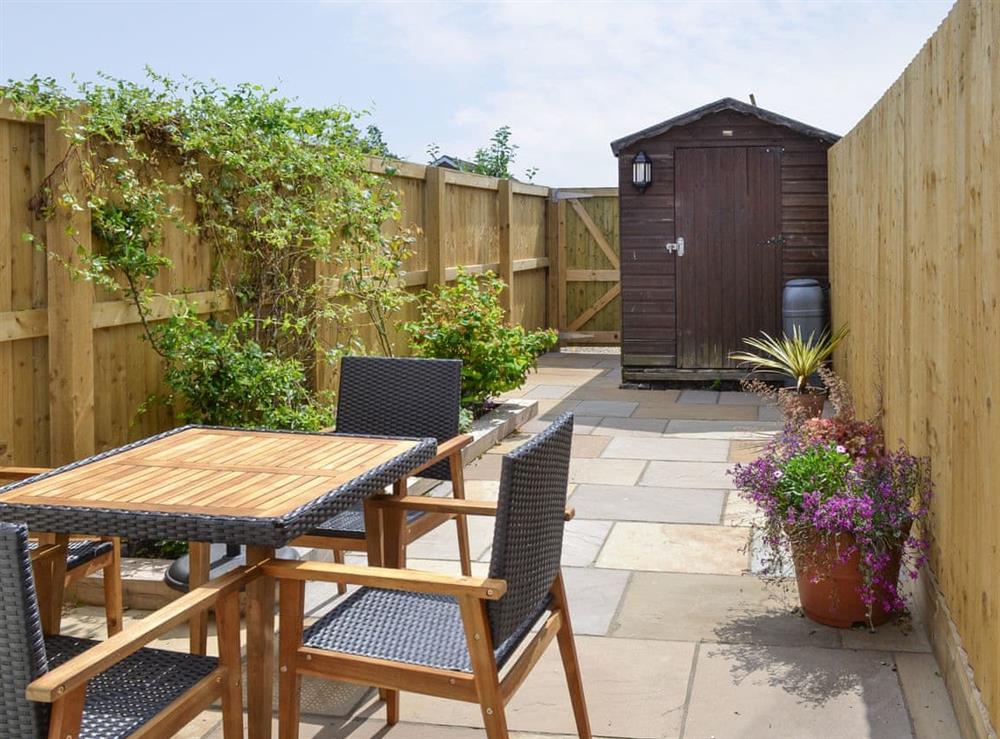 Enclosed courtyard with outdoor furniture at Weavers Cottage in Pickering, North Yorkshire
