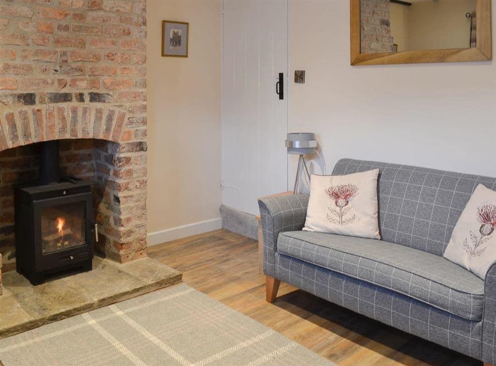 Warming wood burner within living room at Weavers Cottage in Pickering, North Yorkshire