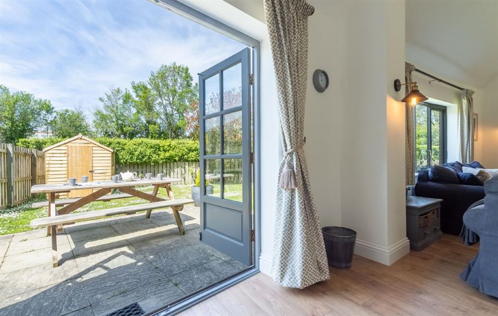 Doors open on to the enclosed patio and garden at Wedge Cottage, Roserrow