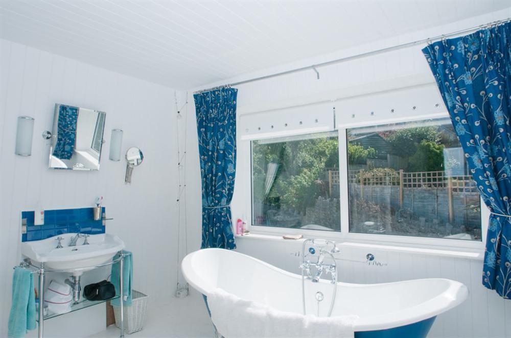 Master bedroom with slipper bath and basin at Wedgwood in Salcombe, Devon