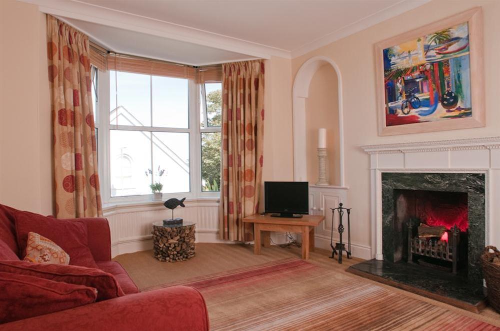 Sitting room with open fire at Wedgwood in Salcombe, Devon