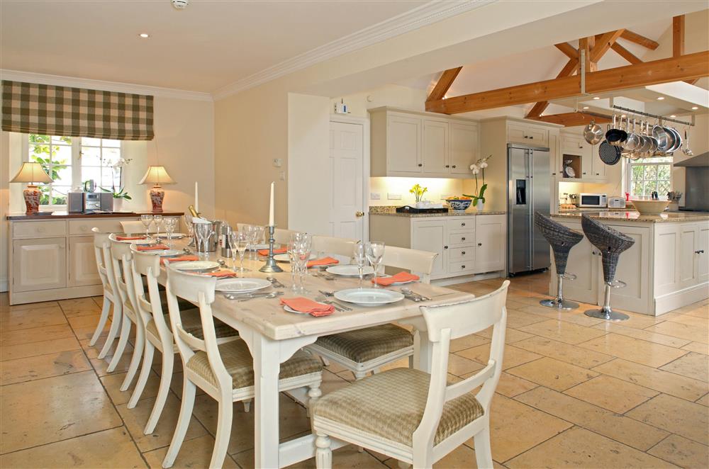The open-plan dining area with table seating 14 guests  at Weir House, Bruern, near Chipping Norton