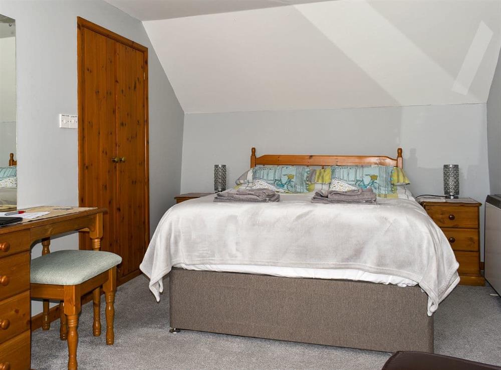 Tranquil double bedroom with sitting area at Cider Cottage, 