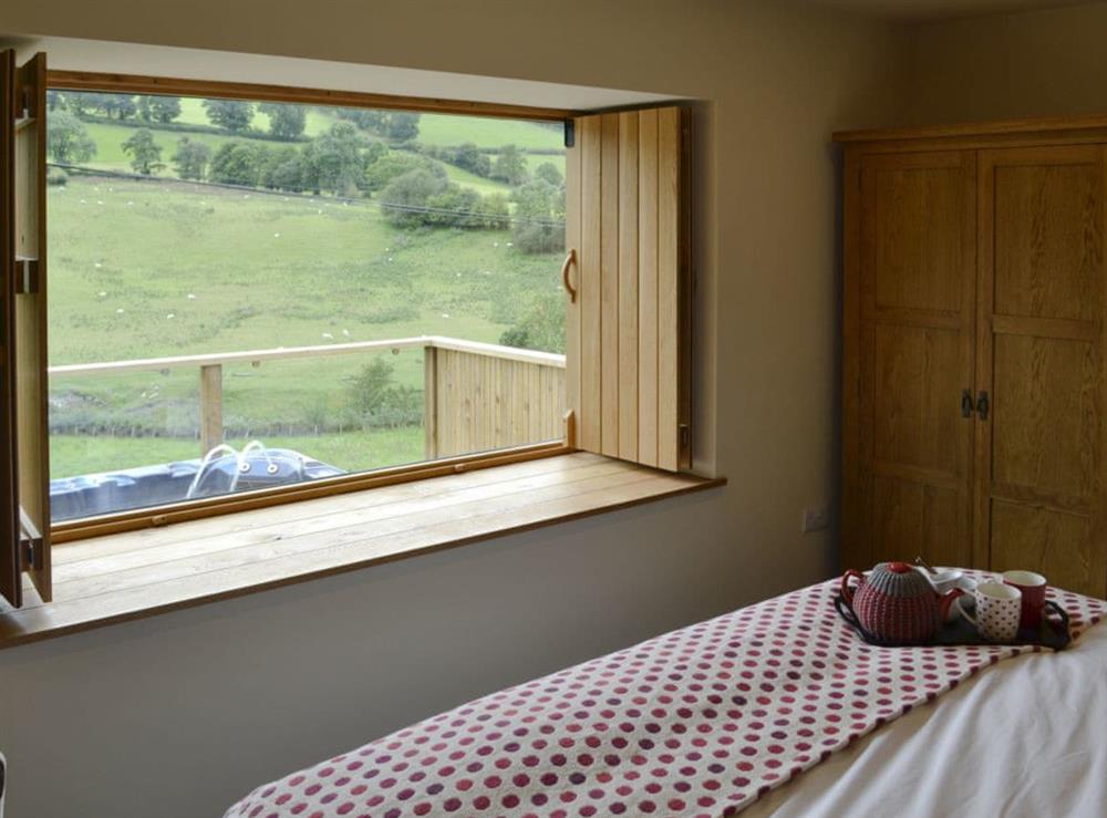 Cosy bedroom looking out on to picturesque views at Wern Ddu Cottage in Penybontfawr, near Oswestry, Powys