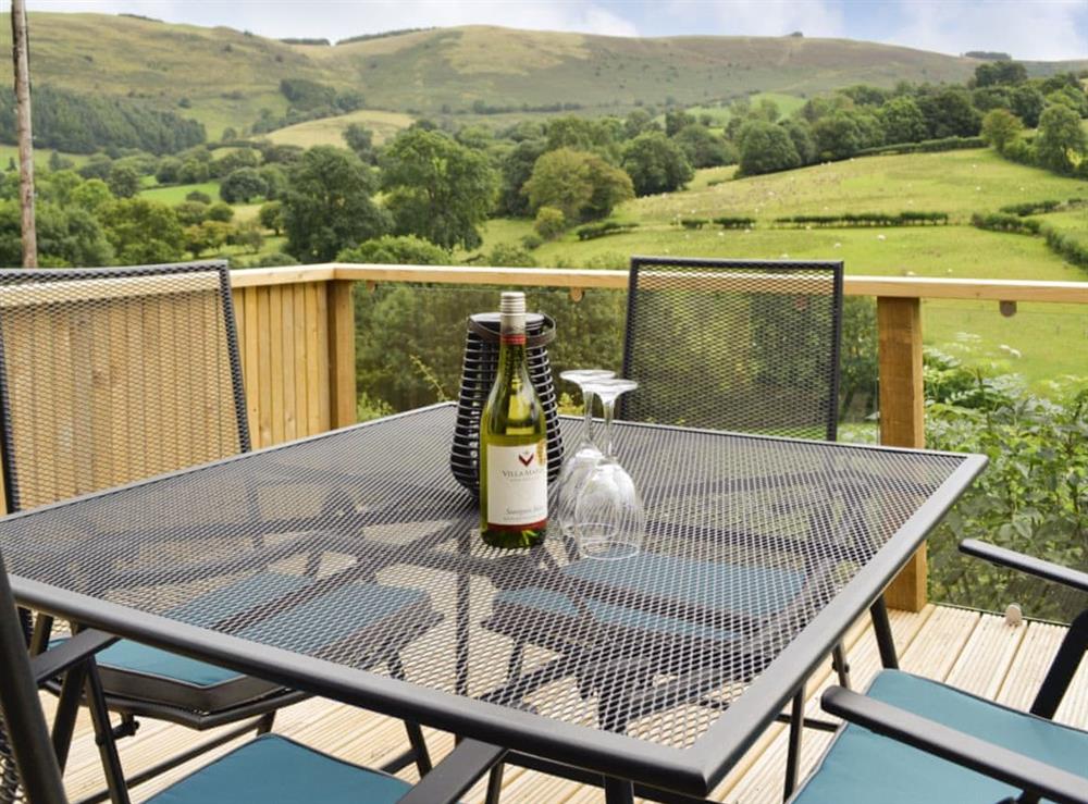 Decked terrace overlooking panoramic scenery at Wern Ddu Cottage in Penybontfawr, near Oswestry, Powys