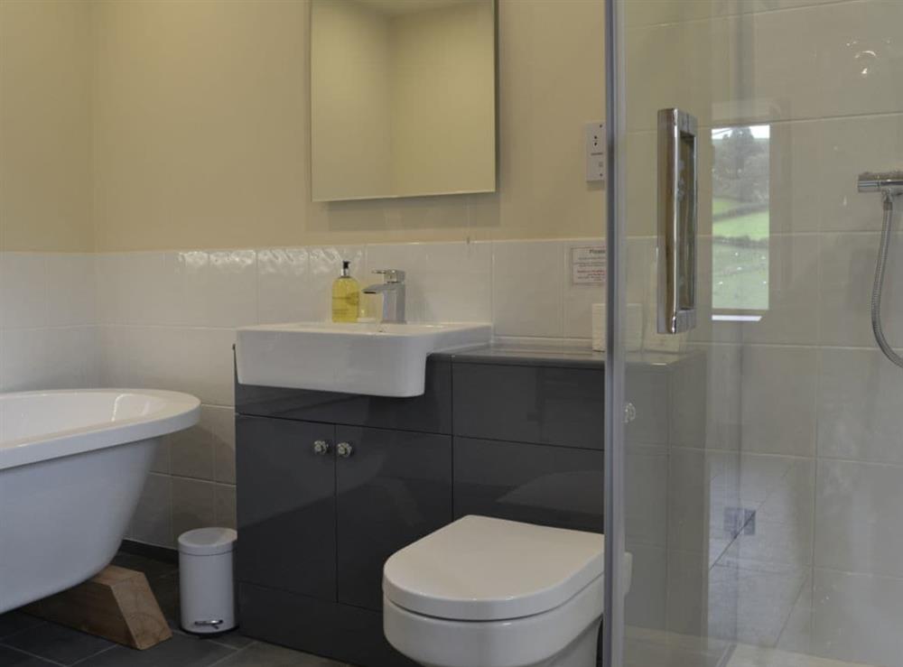 En-suite bathroom with free-standing bath, shower cubicle (photo 2) at Wern Ddu Cottage in Penybontfawr, near Oswestry, Powys