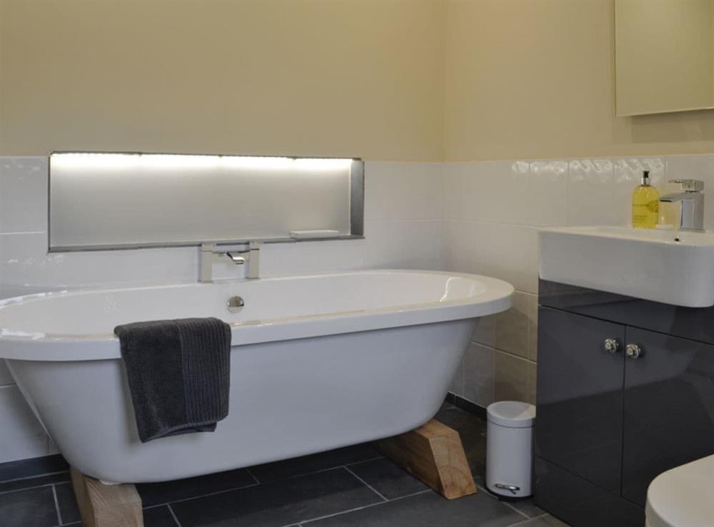 En-suite bathroom with free-standing bath, shower cubicle at Wern Ddu Cottage in Penybontfawr, near Oswestry, Powys