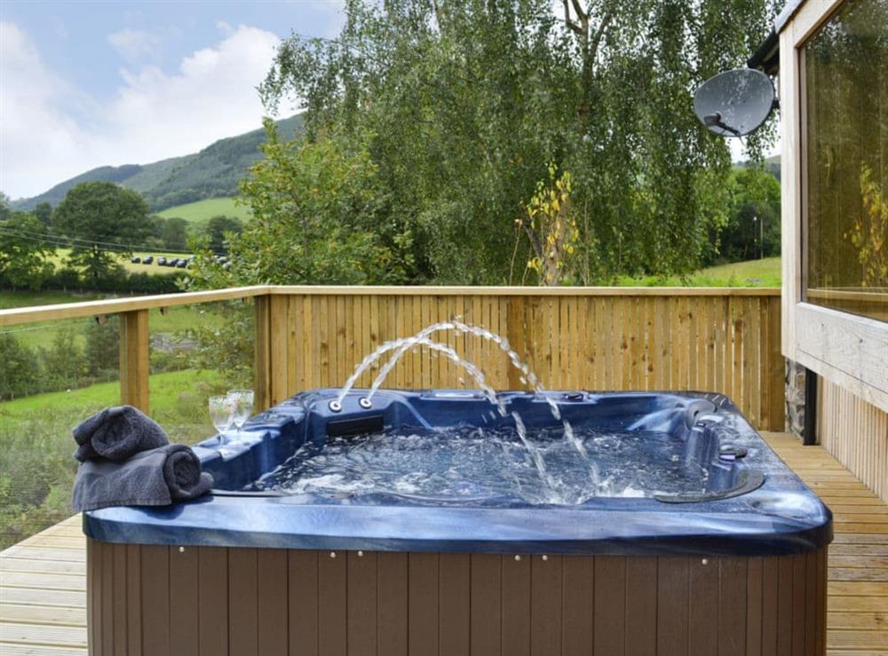 Unwind and enjoy the picturesque scenery in the luxurious hot tub at Wern Ddu Cottage in Penybontfawr, near Oswestry, Powys