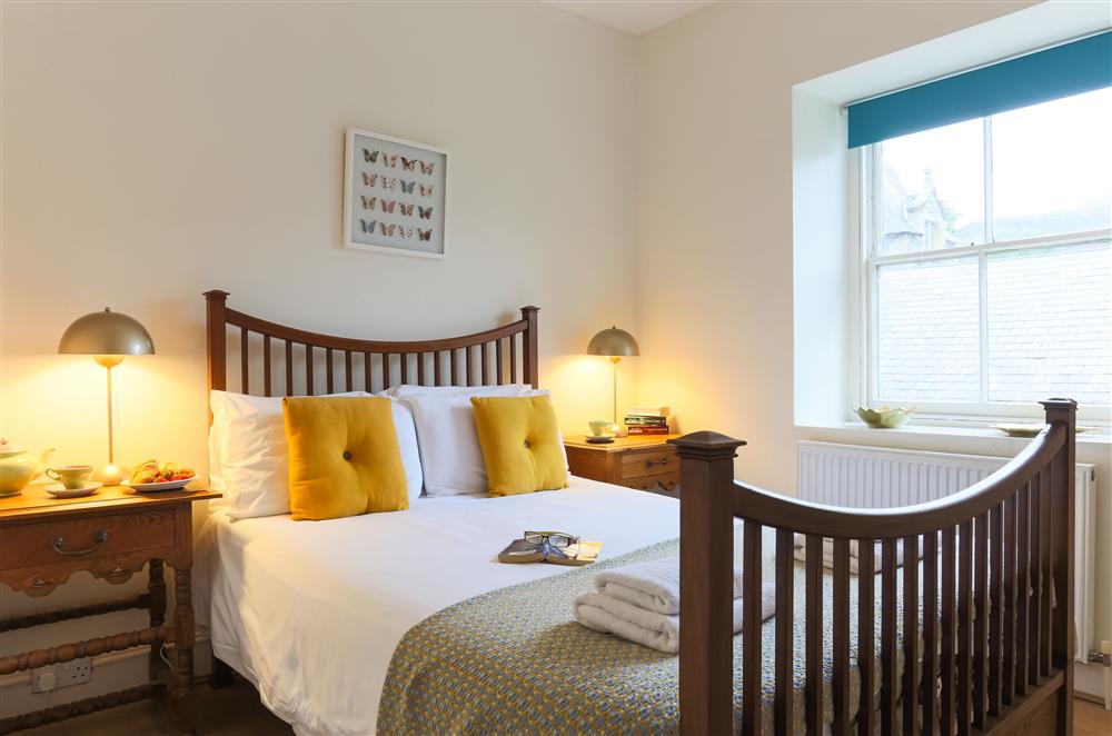 Bedroom one with a 4’6 double bed and en-suite shower room at Wern Manor and Cottages, Porthmadog