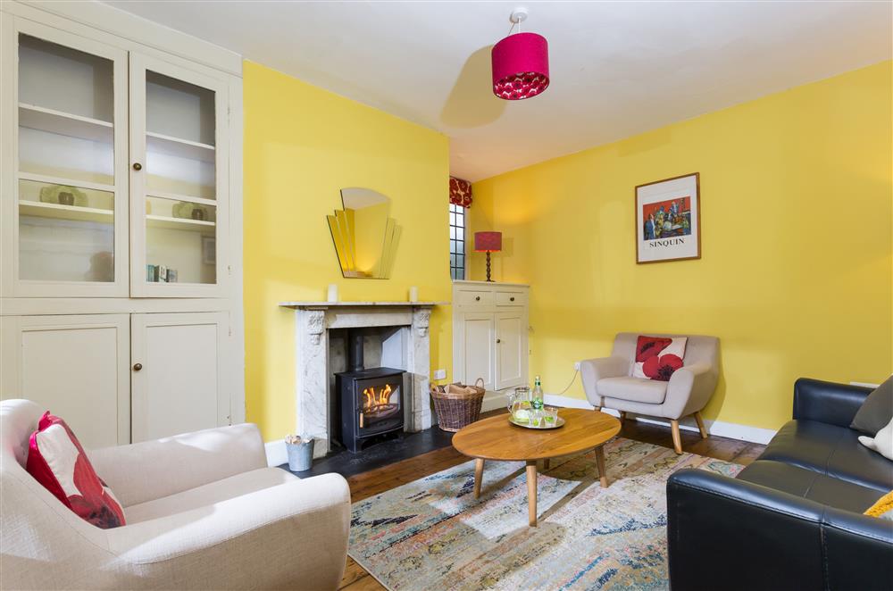 Bright sitting room with wood burning stove at Wern Manor and Cottages, Porthmadog