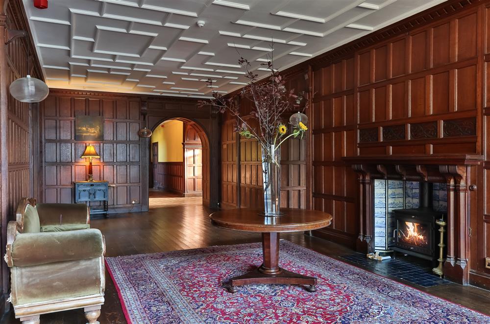 Decadent panelled hall with wood burning stove at Wern Manor and Cottages, Porthmadog