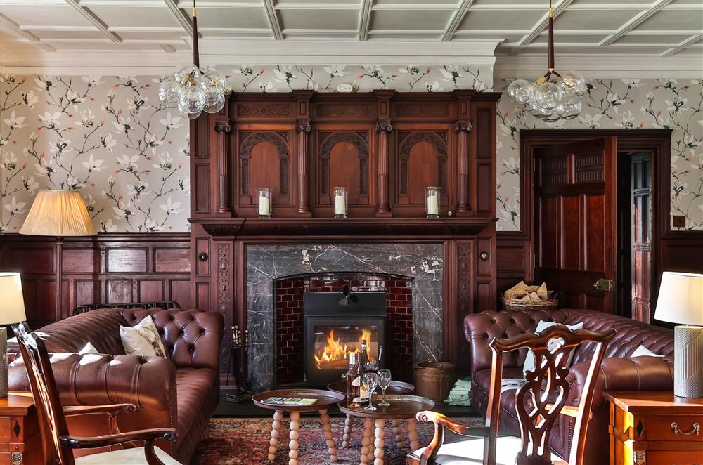 Exquisite grandeur in the sitting room with a wood burning stove at Wern Manor and Cottages, Porthmadog