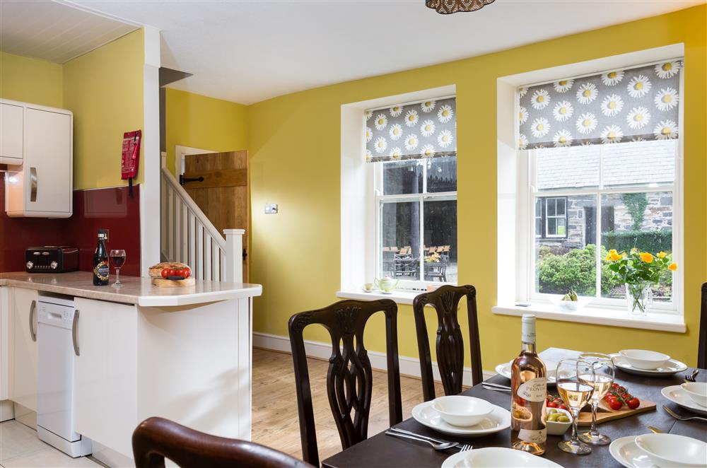 Kitchen and dining room with stairs leading to the first floor at Wern Manor and Cottages, Porthmadog