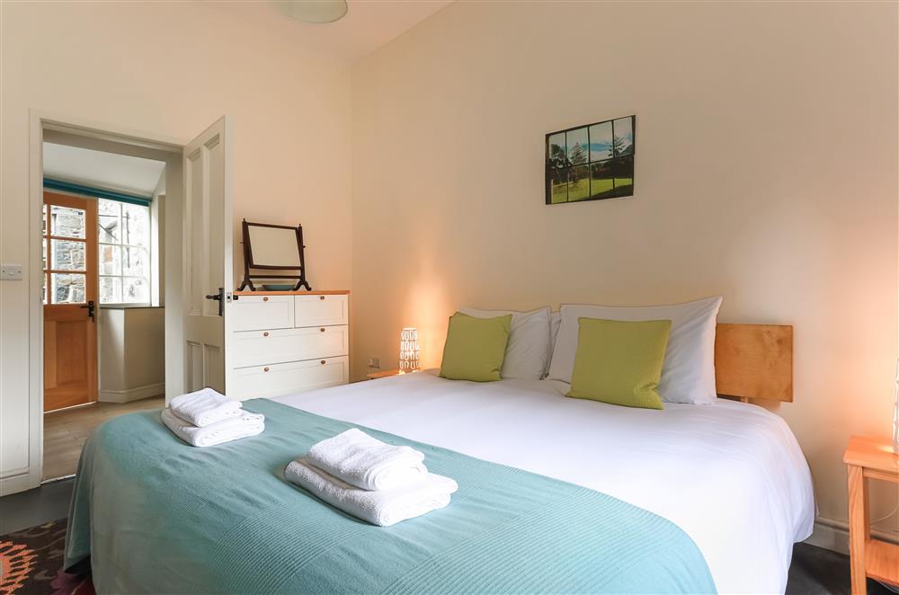 Larder bedroom with a 6’ super-king size zip and link bed and en-suite shower room at Wern Manor, Porthmadog