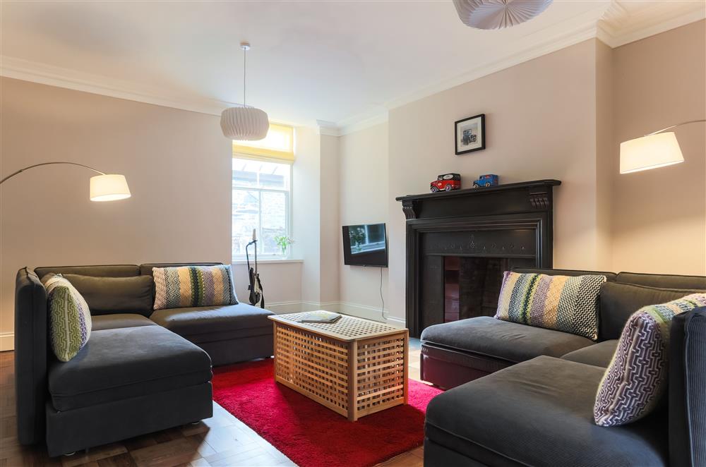 Servants Hall sitting room with four sofas and a Smart television at Wern Manor, Porthmadog