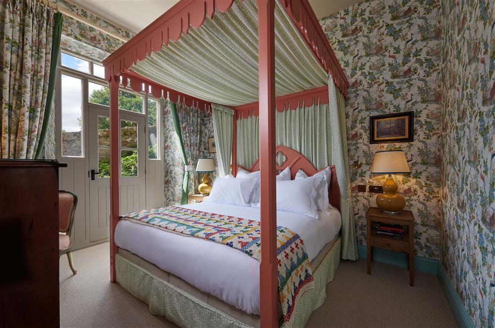 Bedroom four on the lower ground floor, with 4’6 four-poster double bed, en-suite bathroom and door leading to the terrace