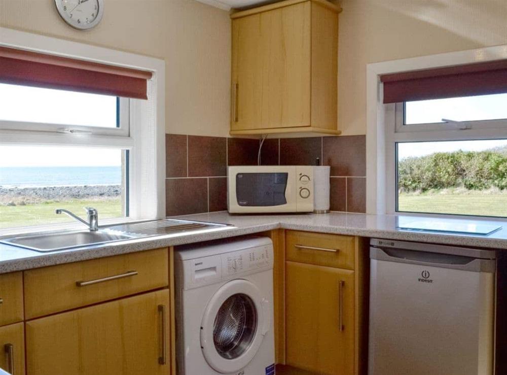 Well-equipped kitchen with dual aspect windows at West Barr Cottage, 