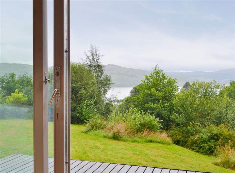 The french doors open up on to a small wooden terrace with views over the Morven Hills at West Bothy in Laga, near Acharacle, Argyll