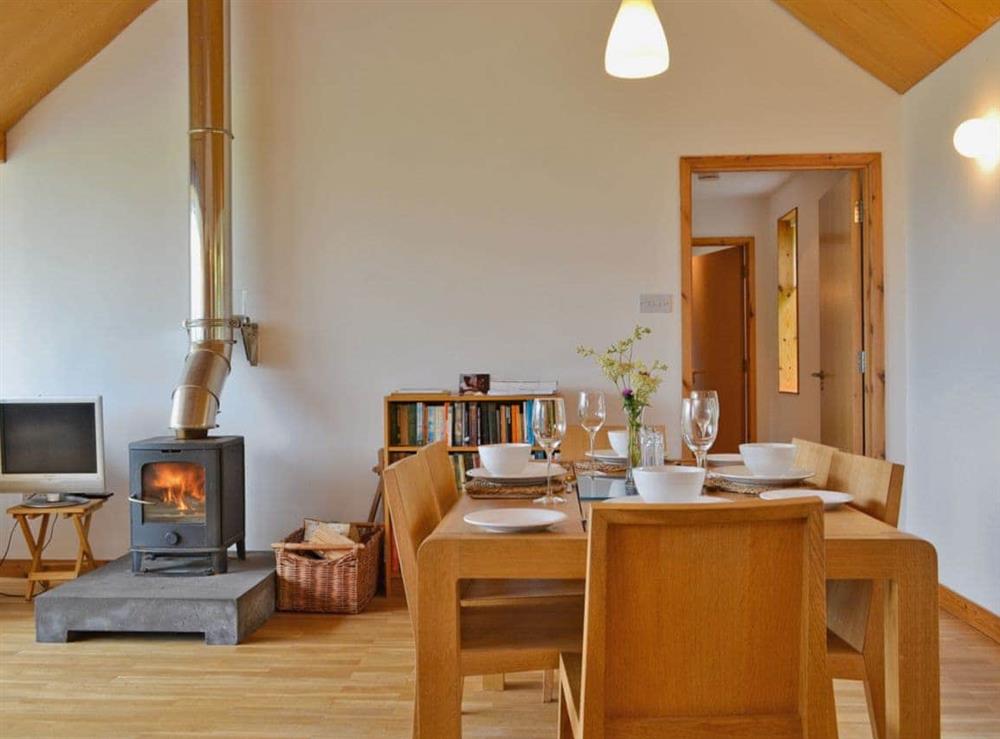 The large dining table easily seats six people for mealtimes with a view at West Bothy in Laga, near Acharacle, Argyll