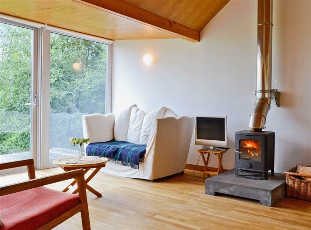 The woodburning stove makes the wood-floored, wood-celienged living area feel warm and cosy at West Bothy in Laga, near Acharacle, Argyll