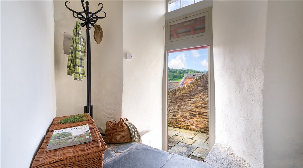 The cloakroom with door to the terrace at West Challacombe Manor in West Exmoor, Devon