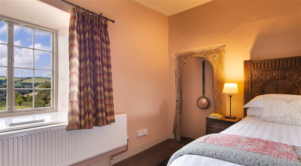The double bedroom, with views over rolling countryside, at West Challacombe Manor in West Exmoor, Devon