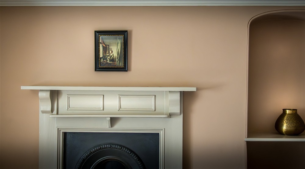 The fireplace in the twin bedroom at West Challacombe Manor in West Exmoor, Devon