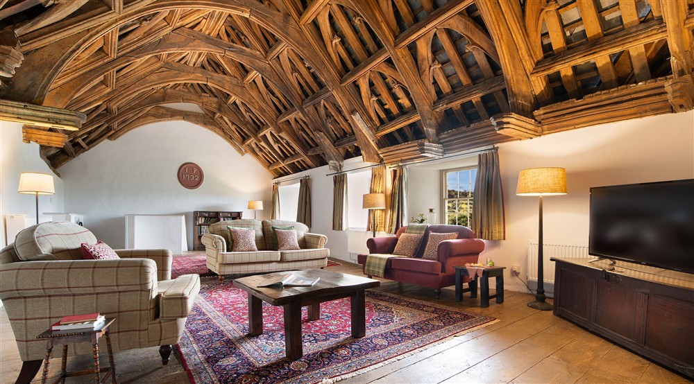 The great hall with original oak hammer beam ceiling at West Challacombe Manor in West Exmoor, Devon