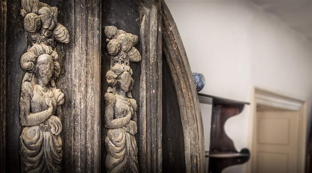 The original oak door with carved figures at West Challacombe Manor in West Exmoor, Devon
